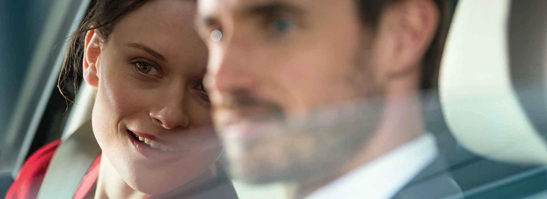 Nahe Aufnahme einer Frau und eines Mannes, die aus dem Auto schauen.