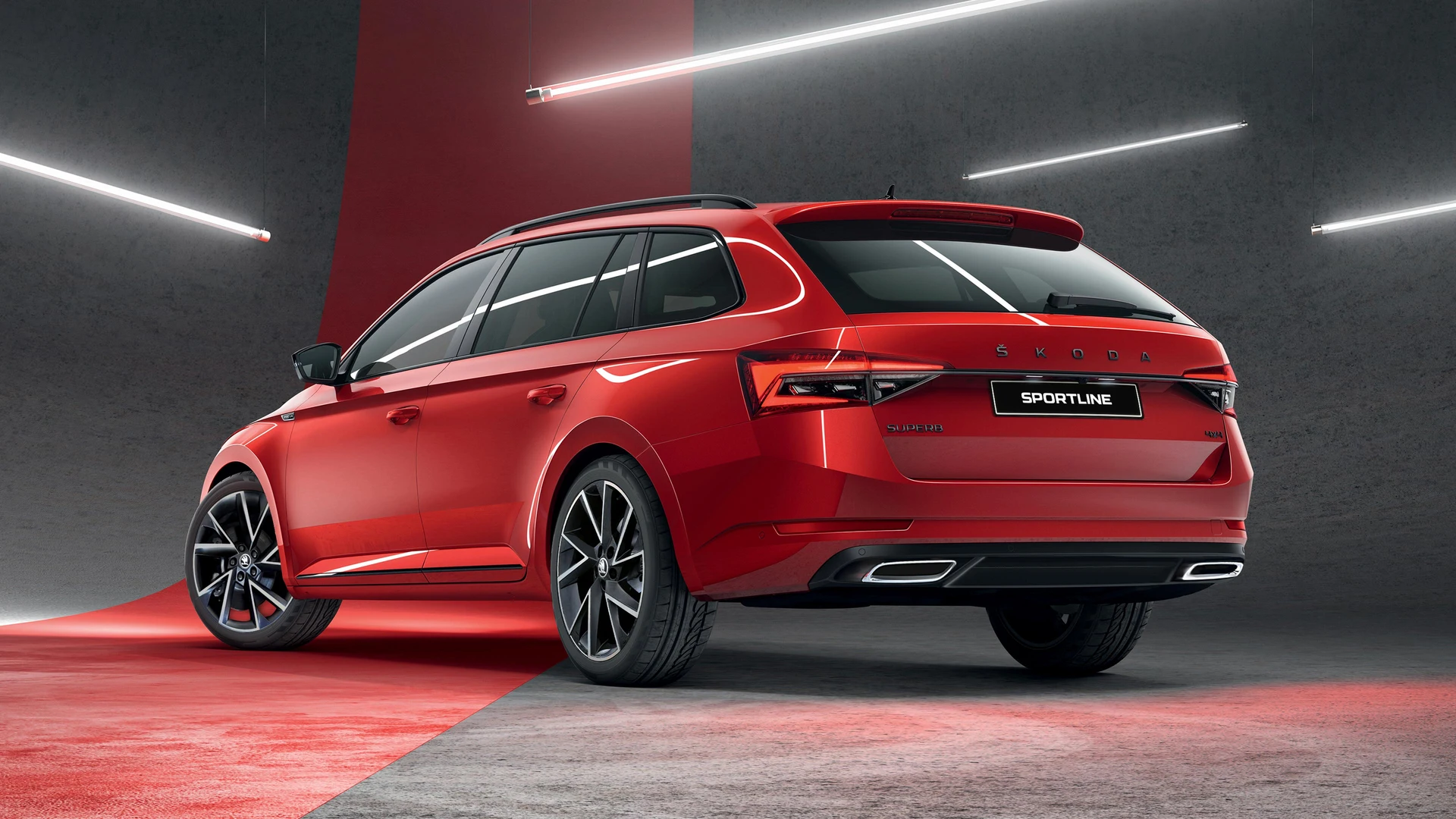 Rear view of 2024 Škoda Superb Sportline 4x4 Wagon in red featuring VEGA alloy wheels and gloss black roof rails – overseas model shown