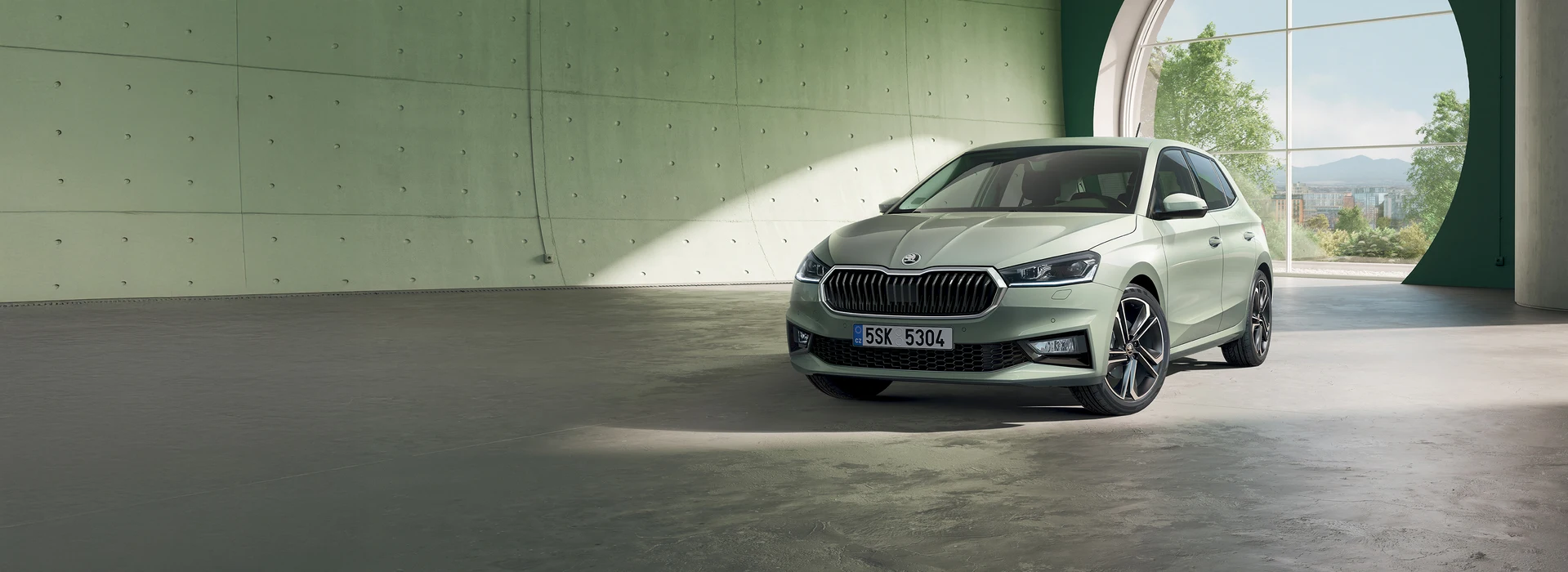 Škoda Fabia driving through the daytime street, front angle, phoenix orange metallic color