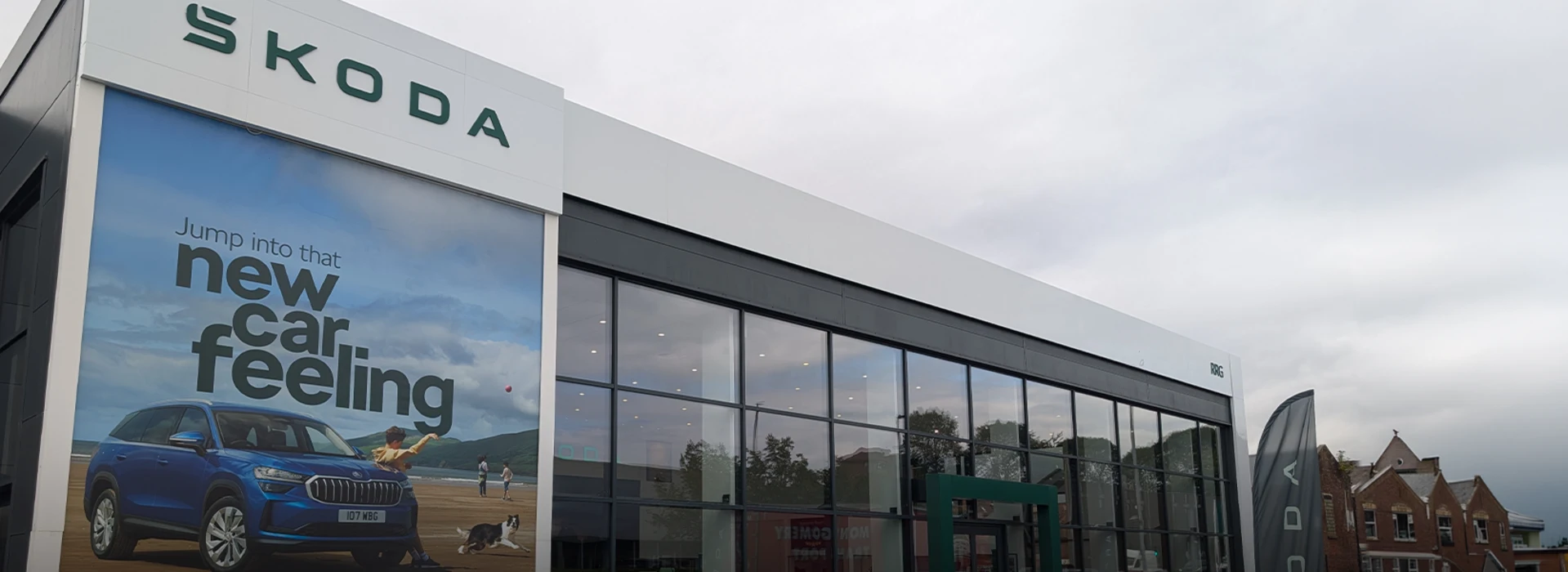 Škoda RRG Bolton dealership building with a large display poster and modern glass showroom.