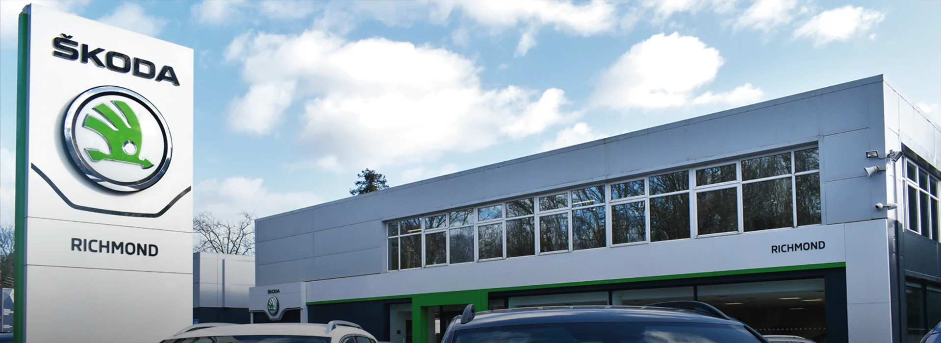 Exterior view of the Škoda Richmond dealership building featuring prominent brand entrance signage.