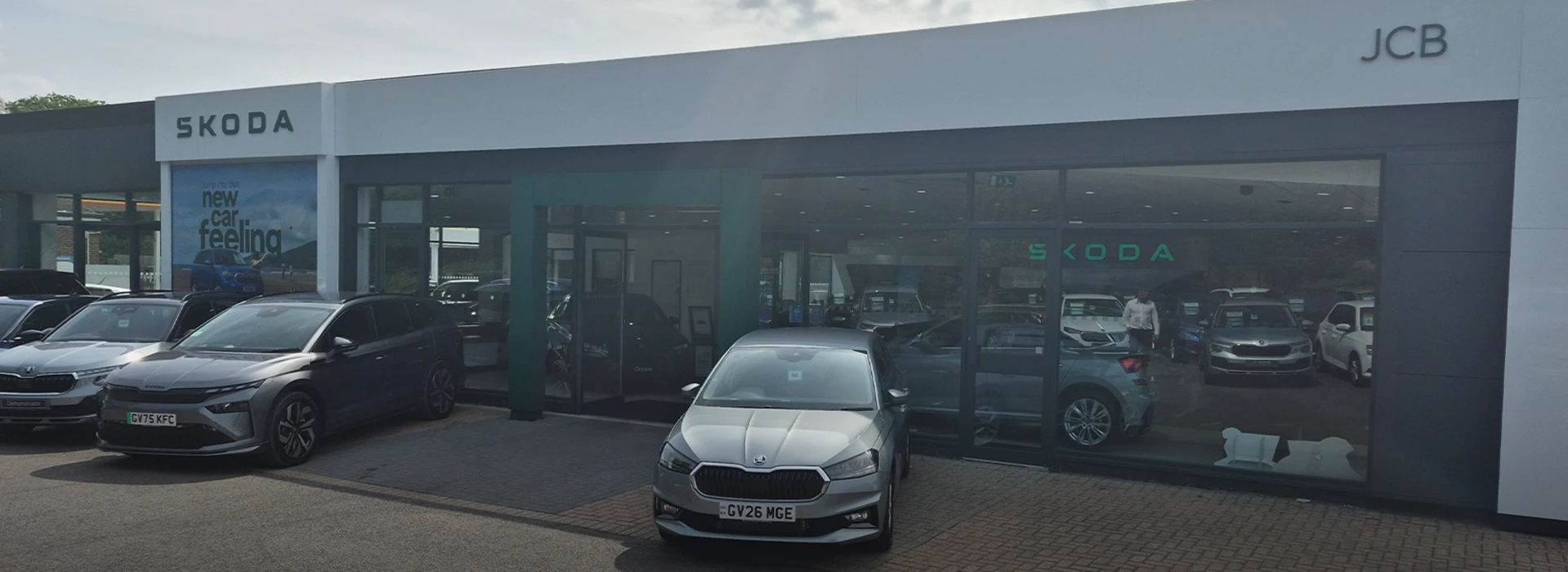 Škoda JCB Crawley dealership showroom exterior with cars parked outside.