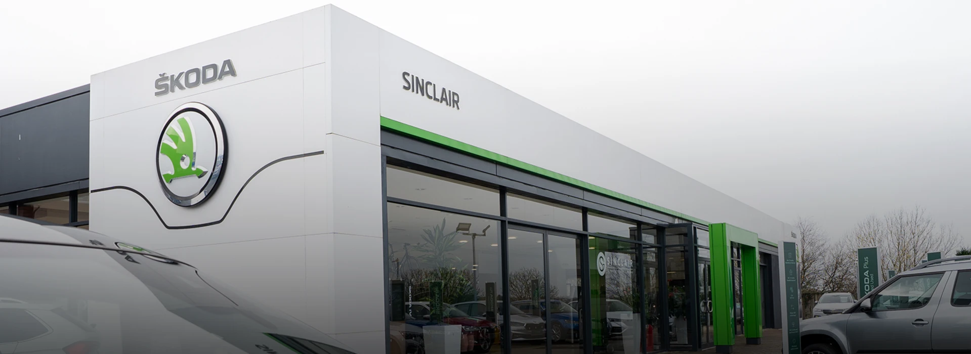 Škoda Sinclair Swansea dealership building with modern glass entrance and branded logo.