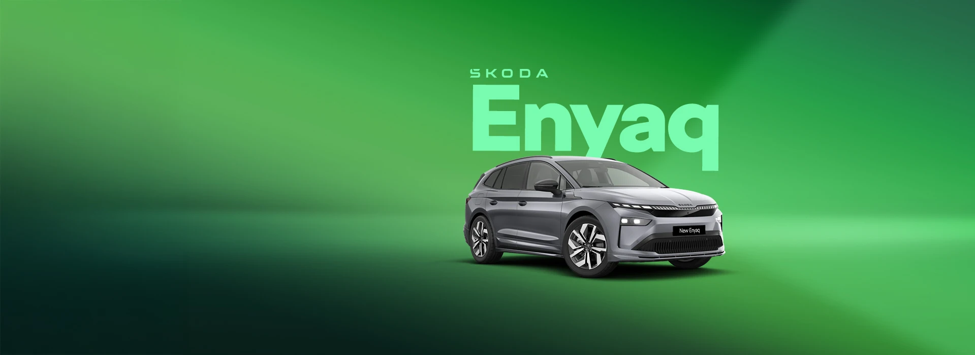 "Enyaq" - Silver Škoda Enyaq in a green studio