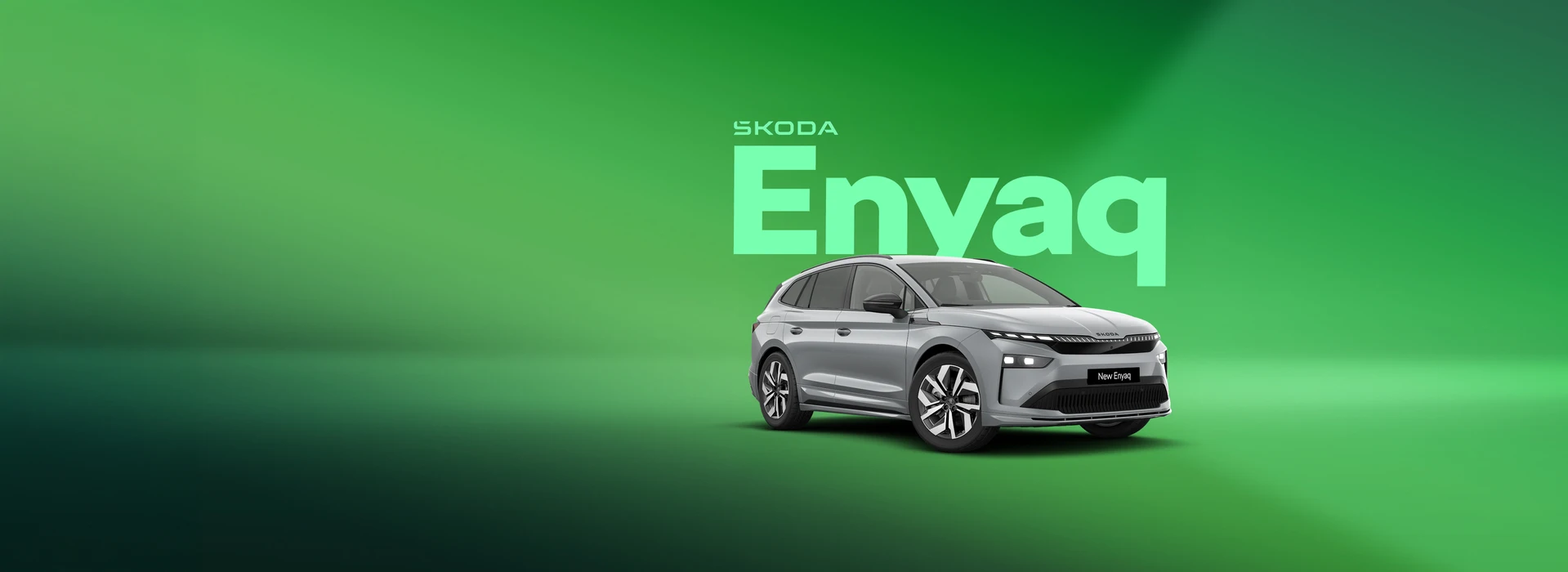 "Enyaq" - Silver Škoda Enyaq in a green studio