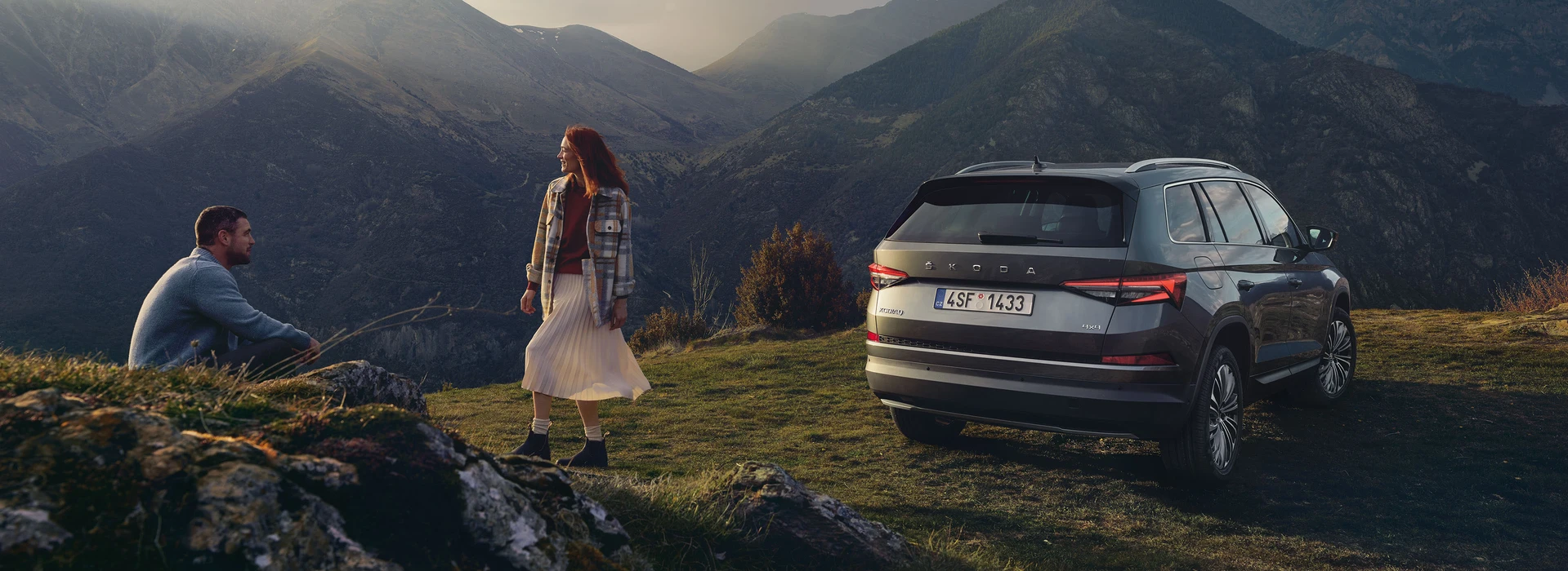 a couple hanging outside, kodiaq in the back