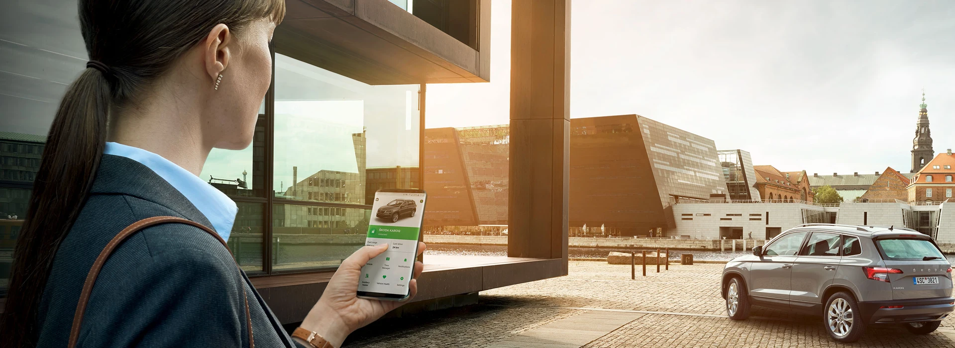 Una donna che usa l’app ŠKODA Connect.